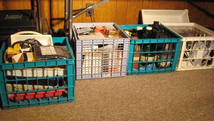 Milk crates full of film developing tools, trays, developing cylinders and solutions. 