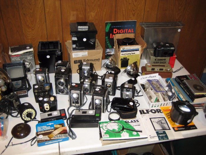 Collection of vintage cameras and extra lenses.