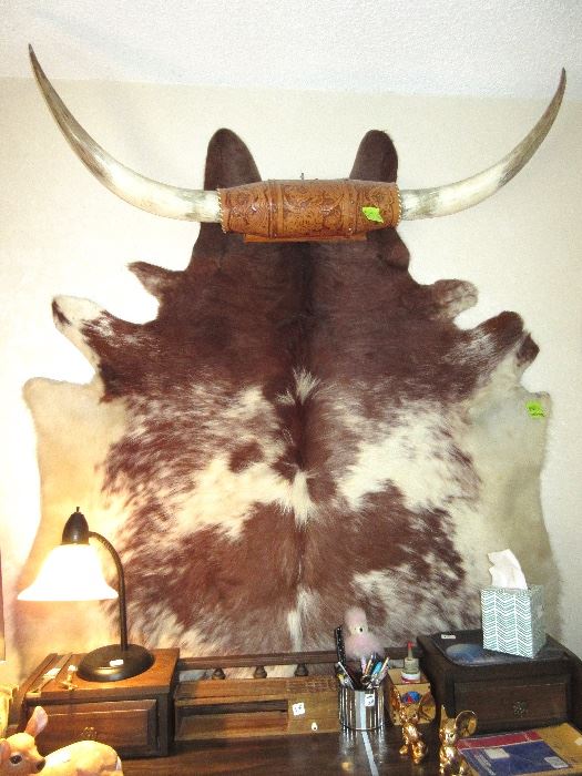OK, all of your Western fans, a tooled leather Texas long horn, on top of a steer hide. both are in wonderful condition.
