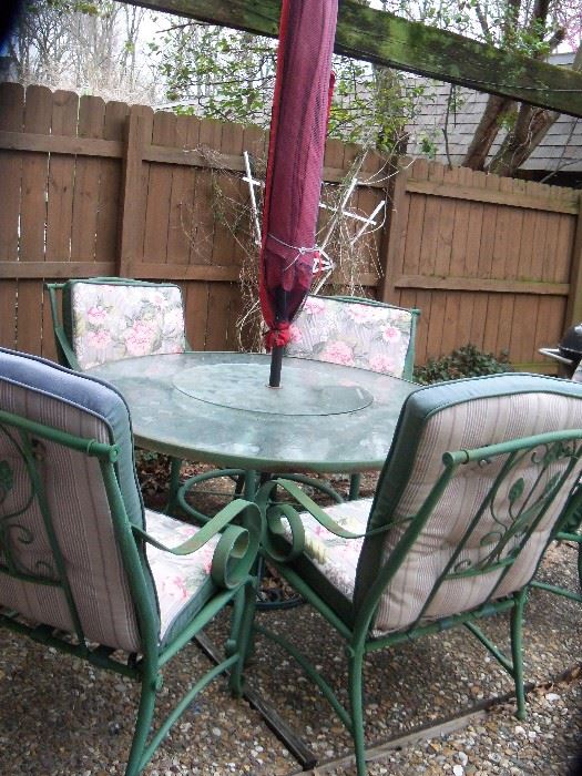 Patio  set, 6 chairs, table with lazy susan, umbrella and stand.  Some of the chairs need the seat straps replaced.  Very heavy set