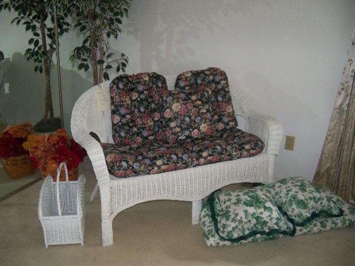wicker settee with two sets of cushions, magazine basket, artificial tree