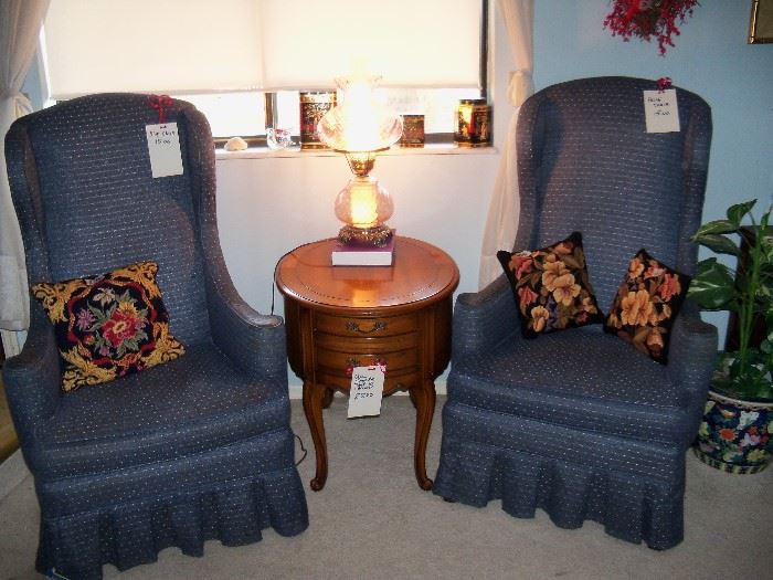 pair of highback chairs, needlepoint pillows and cute oval table with drawers.  Lamp and misc.