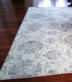 Beautiful 8x10 area rug muted tones of blue and gray on cream background