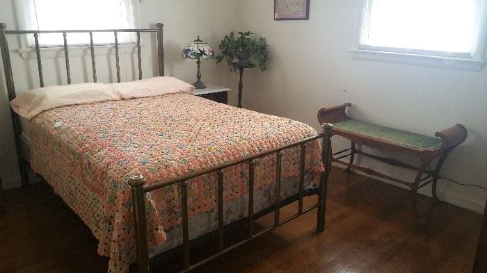 Brass bed with yo yo quilt and oak bench