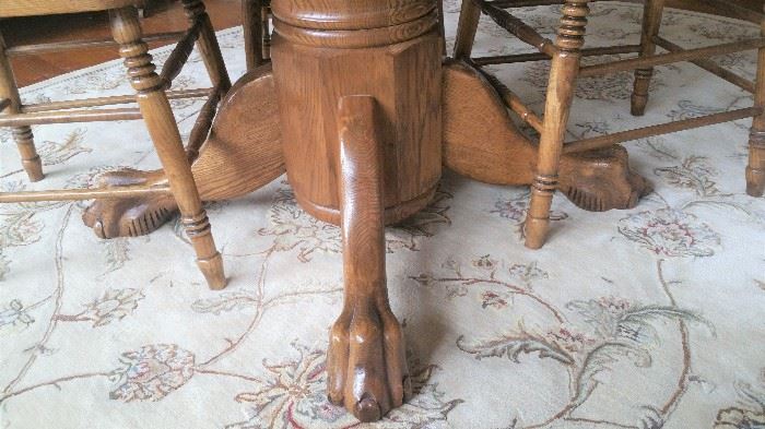Pedestal with lions claw feet on Oak dining table 