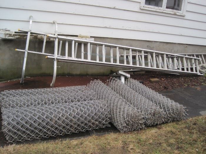 two big ladders & chain link fence