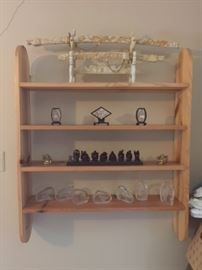 shelf with ivory like sheathed swords, Buddhas and crystal