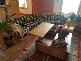 curved rattan sofa with coastal fabric cushions