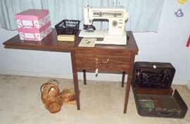 Sewing machine in cabinet & an antique sewing machine in carrying case