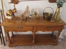 Console Table showing Brass Animal Sculpture and Accessories