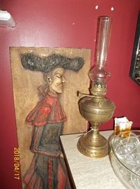Russian oil lamp, punch bowl and cups, wall art, items are sitting on a console bar
