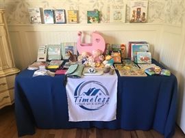 Room full of kid's books, toys and clothing