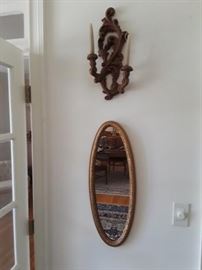 Candle sconce and oval mirror
