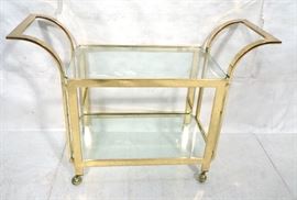 Lot 187 Modern Brass  Glass Rolling Bar Cart. Two glass 