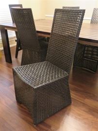 Set of four woven leather parson's style side chairs.