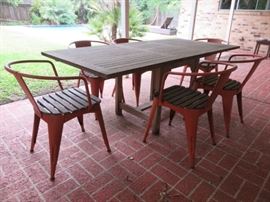 Pottery Barn teak/painted metal extending dining table with six matching chairs.