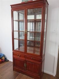 Mahogany finish bookcase/curio cabinet with beveled glass doors/side panels.