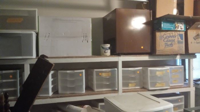 Lots of empty drawered bins, brown mini fridge