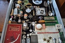 We have a LOT more to fit in this display case!  Sterling, miniature Toby jugs, vintage Gerber measuring tape, jewelry (not all pictured), KLM miniature house, Oldsmobile radiator shroud emblem... and more!