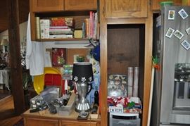 Kitchen utensils many new with tags, lamp created from large coffee pot, food containers new in package, several sets of flatware,, trays, cookbooks