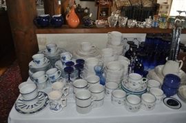 Several sets of china including Pfaltzgraff, a "ticking" pattern, blue floral, cobalt blue drinking glasses in two sizes, cobalt and clear wine glasses, cobalt blue wine glasses, 