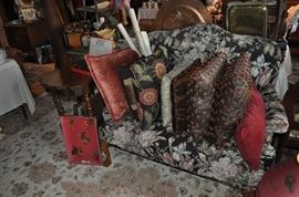 High back floral settee, decorator pillows, maps and posters, wooden tray