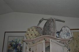 The amazing armoire -- PACKED with all sorts of pretty sheets and shams and pillowcases... a table FULL of really cool hatboxes and several are old.   Zoom in to see even more treasures!  Oh -- there's a really pretty chair on top of the armoire with a couple more hat boxes.  