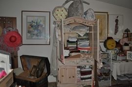 Super awesome domed trunk with a vintage photo... The amazing armoire -- PACKED with all sorts of pretty sheets and shams and pillowcases... a table FULL of really cool hatboxes and several are old.   Zoom in to see even more treasures!  Oh -- there's a really pretty chair on top of the armoire with a couple more hat boxes.  