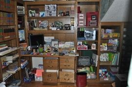 This is the library just outside of that enormous master bedroom.  FULL of books and office supplies, cups and saucers, folders, magazine holders, photo boxes, printers, scissors, greeting cards, some fine porcelain, lots of old cigar boxes, an office chair... a vintage typewriter, paper, a monitor, oodles of pens and pencils, staplers, tape dispensers, more books, envelopes, an awesome fish decanter, a Wild Turkey decanter, and... there is really a LOT more!