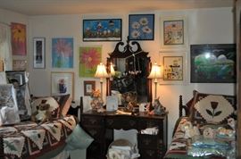 The girls' room... totally set up for her two adorable grandchildren.  That is an amazing antique Thomasville vanity with mirror, a pair of twin spool beds covered with quilts and other treasures... loads of art on the walls, an antique armoire, the best ever antique rocking chair, a spinet desk, and a trunk (antique) full of porcelain dolls.  Oh... and a closet full of more clothes, bedding, a corner etagere... and more stuff I can't remember!