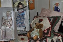 The girls' room... totally set up for her two adorable grandchildren.  That is an amazing antique Thomasville vanity with mirror, a pair of twin spool beds covered with quilts and other treasures... loads of art on the walls, an antique armoire, the best ever antique rocking chair, a spinet desk, and a trunk (antique) full of porcelain dolls.  Oh... and a closet full of more clothes, bedding, a corner etagere... and more stuff I can't remember!