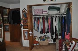 The girls' room... totally set up for her two adorable grandchildren.  That is an amazing antique Thomasville vanity with mirror, a pair of twin spool beds covered with quilts and other treasures... loads of art on the walls, an antique armoire, the best ever antique rocking chair, a spinet desk, and a trunk (antique) full of porcelain dolls.  Oh... and a closet full of more clothes, bedding, a corner etagere... and more stuff I can't remember!