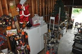 And now the garage... the garage EVERY guy wants to own... nearly 800sf and pretty close to two stories tall!   5ft stainless junction box, air tools, animated 5ft santa, Aquaflow pump, building supplies, camping supplies, Christmas and holiday items, cleaning supplies, commercial painting equipment and supplies, contractor’s equipment, Craftsman tool boxes, extensions cords, fishing collectibles antique and vintage, fishing equipment new and old, fishing rods and reels, garden art TONS, garden fertilizers and more, gardening supplies and tools hundreds, Imperial 6 burner stove/oven, ladders, Livingston 2 person fiberglass boat, loading ramps, Lorex cookware fan, Minnkota trolling motor, outdoor pots, paint sprayers, pet supplies, picnic table, plants, plastic bins all sizes, plumbing supplies, refrigerator, secretary with glass doors above drop front with drawers, front with drawers, Zero gravity outdoor chair… and the regular stuff – saws, hammers, wrenches, plumbing stuff, screwdriv