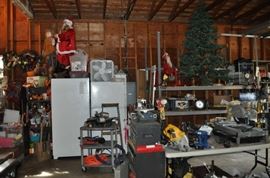 And now the garage... the garage EVERY guy wants to own... nearly 800sf and pretty close to two stories tall!   5ft stainless junction box, air tools, animated 5ft santa, Aquaflow pump, building supplies, camping supplies, Christmas and holiday items, cleaning supplies, commercial painting equipment and supplies, contractor’s equipment, Craftsman tool boxes, extensions cords, fishing collectibles antique and vintage, fishing equipment new and old, fishing rods and reels, garden art TONS, garden fertilizers and more, gardening supplies and tools hundreds, Imperial 6 burner stove/oven, ladders, Livingston 2 person fiberglass boat, loading ramps, Lorex cookware fan, Minnkota trolling motor, outdoor pots, paint sprayers, pet supplies, picnic table, plants, plastic bins all sizes, plumbing supplies, refrigerator, secretary with glass doors above drop front with drawers, front with drawers, Zero gravity outdoor chair… and the regular stuff – saws, hammers, wrenches, plumbing stuff, screwdriv