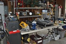 And now the garage... the garage EVERY guy wants to own... nearly 800sf and pretty close to two stories tall!   5ft stainless junction box, air tools, animated 5ft santa, Aquaflow pump, building supplies, camping supplies, Christmas and holiday items, cleaning supplies, commercial painting equipment and supplies, contractor’s equipment, Craftsman tool boxes, extensions cords, fishing collectibles antique and vintage, fishing equipment new and old, fishing rods and reels, garden art TONS, garden fertilizers and more, gardening supplies and tools hundreds, Imperial 6 burner stove/oven, ladders, Livingston 2 person fiberglass boat, loading ramps, Lorex cookware fan, Minnkota trolling motor, outdoor pots, paint sprayers, pet supplies, picnic table, plants, plastic bins all sizes, plumbing supplies, refrigerator, secretary with glass doors above drop front with drawers, front with drawers, Zero gravity outdoor chair… and the regular stuff – saws, hammers, wrenches, plumbing stuff, screwdriv