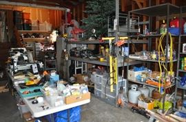 And now the garage... the garage EVERY guy wants to own... nearly 800sf and pretty close to two stories tall!   5ft stainless junction box, air tools, animated 5ft santa, Aquaflow pump, building supplies, camping supplies, Christmas and holiday items, cleaning supplies, commercial painting equipment and supplies, contractor’s equipment, Craftsman tool boxes, extensions cords, fishing collectibles antique and vintage, fishing equipment new and old, fishing rods and reels, garden art TONS, garden fertilizers and more, gardening supplies and tools hundreds, Imperial 6 burner stove/oven, ladders, Livingston 2 person fiberglass boat, loading ramps, Lorex cookware fan, Minnkota trolling motor, outdoor pots, paint sprayers, pet supplies, picnic table, plants, plastic bins all sizes, plumbing supplies, refrigerator, secretary with glass doors above drop front with drawers, front with drawers, Zero gravity outdoor chair… and the regular stuff – saws, hammers, wrenches, plumbing stuff, screwdriv