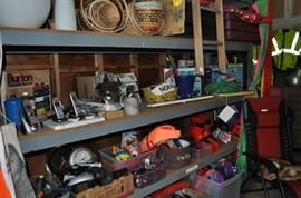 And now the garage... the garage EVERY guy wants to own... nearly 800sf and pretty close to two stories tall!   5ft stainless junction box, air tools, animated 5ft santa, Aquaflow pump, building supplies, camping supplies, Christmas and holiday items, cleaning supplies, commercial painting equipment and supplies, contractor’s equipment, Craftsman tool boxes, extensions cords, fishing collectibles antique and vintage, fishing equipment new and old, fishing rods and reels, garden art TONS, garden fertilizers and more, gardening supplies and tools hundreds, Imperial 6 burner stove/oven, ladders, Livingston 2 person fiberglass boat, loading ramps, Lorex cookware fan, Minnkota trolling motor, outdoor pots, paint sprayers, pet supplies, picnic table, plants, plastic bins all sizes, plumbing supplies, refrigerator, secretary with glass doors above drop front with drawers, front with drawers, Zero gravity outdoor chair… and the regular stuff – saws, hammers, wrenches, plumbing stuff, screwdriv