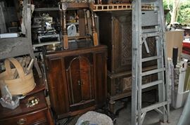 And now the garage... the garage EVERY guy wants to own... nearly 800sf and pretty close to two stories tall!   5ft stainless junction box, air tools, animated 5ft santa, Aquaflow pump, building supplies, camping supplies, Christmas and holiday items, cleaning supplies, commercial painting equipment and supplies, contractor’s equipment, Craftsman tool boxes, extensions cords, fishing collectibles antique and vintage, fishing equipment new and old, fishing rods and reels, garden art TONS, garden fertilizers and more, gardening supplies and tools hundreds, Imperial 6 burner stove/oven, ladders, Livingston 2 person fiberglass boat, loading ramps, Lorex cookware fan, Minnkota trolling motor, outdoor pots, paint sprayers, pet supplies, picnic table, plants, plastic bins all sizes, plumbing supplies, refrigerator, secretary with glass doors above drop front with drawers, front with drawers, Zero gravity outdoor chair… and the regular stuff – saws, hammers, wrenches, plumbing stuff, screwdriv