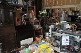 And now the garage... the garage EVERY guy wants to own... nearly 800sf and pretty close to two stories tall!   5ft stainless junction box, air tools, animated 5ft santa, Aquaflow pump, building supplies, camping supplies, Christmas and holiday items, cleaning supplies, commercial painting equipment and supplies, contractor’s equipment, Craftsman tool boxes, extensions cords, fishing collectibles antique and vintage, fishing equipment new and old, fishing rods and reels, garden art TONS, garden fertilizers and more, gardening supplies and tools hundreds, Imperial 6 burner stove/oven, ladders, Livingston 2 person fiberglass boat, loading ramps, Lorex cookware fan, Minnkota trolling motor, outdoor pots, paint sprayers, pet supplies, picnic table, plants, plastic bins all sizes, plumbing supplies, refrigerator, secretary with glass doors above drop front with drawers, front with drawers, Zero gravity outdoor chair… and the regular stuff – saws, hammers, wrenches, plumbing stuff, screwdriv