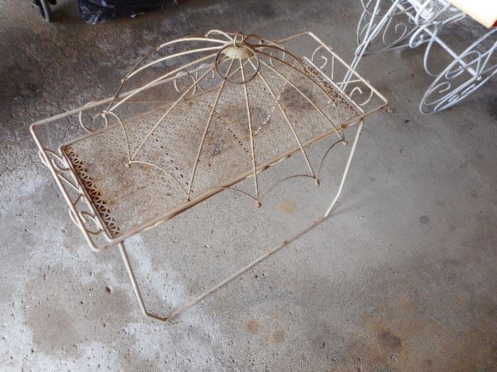 Vintage White Wrought Iron Decorative Umbrella sitting on top Table