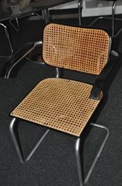 One of the 8 Breuer wicker and chrome black arm dining chairs available by Stendig. (some need caning repair)