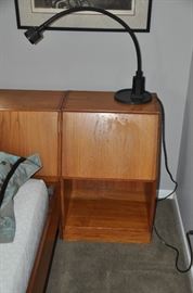 One of the two teak nightstands (18.5"w x 29"h x 15"d) with a mid century black Levenger gooseneck adjustable table lamp. 