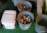 old golf balls and bucket of baseballs
