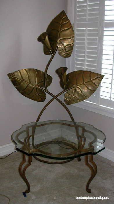 Copper Standing Lamp behind a Glass and Metal Table