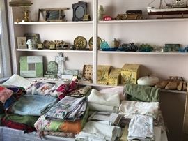 Kitchen and bedroom linens & decorative items including vintage Avon cologne bottles.