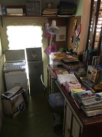 Office area adjacent to the kitchen, typewriter, file cabinets and Kodak photo printer.