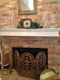 Brass fireplace tools, fire screen, and log holder; mantle clock