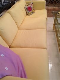 1 of 2 sleek 4-cushion yellow sofas