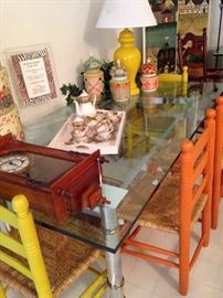 Four of the several brightly colored ladder back/rush seat chairs