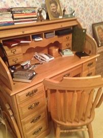 Roll top desk and chair in light wood; desk phone